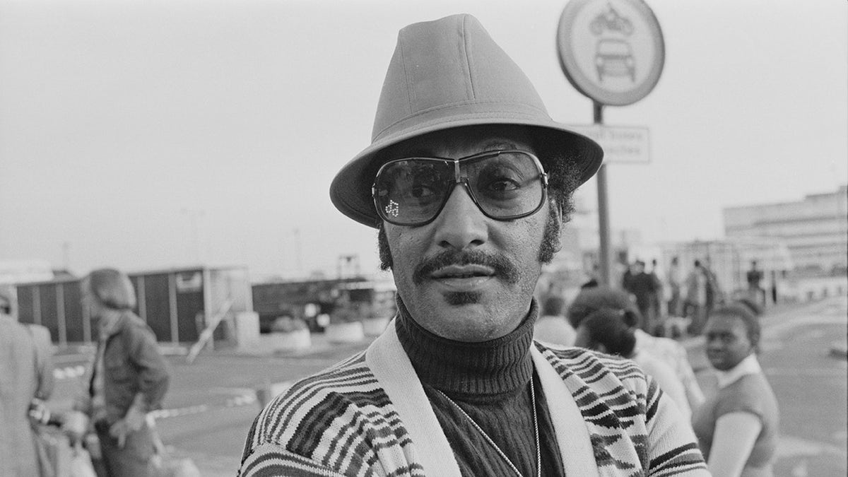 Abdul Duke Fakir wears a hat and sweater.