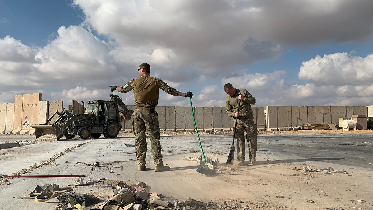 Troops cleaning up rubble at Ain Al-Asad airbase