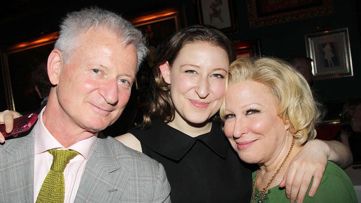A photo of Bette Midler with her husband and daughter