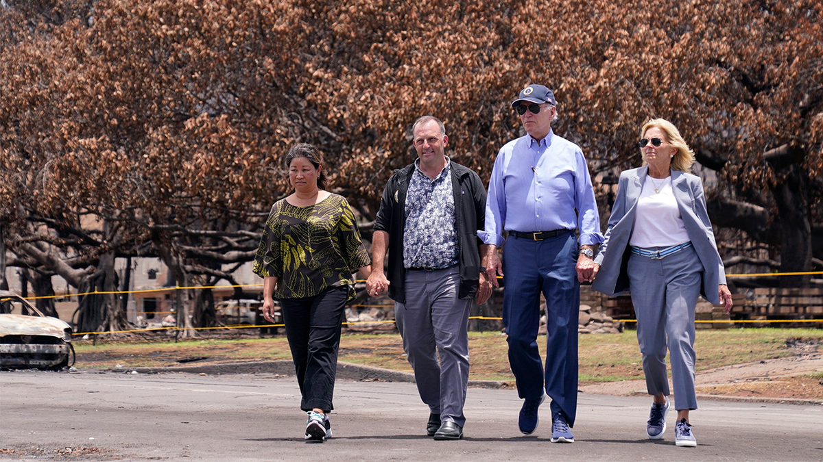 President Joe Biden and first lady Jill Biden walk with Hawaii Gov. Josh Green, second from left, and his wife Jaime Green