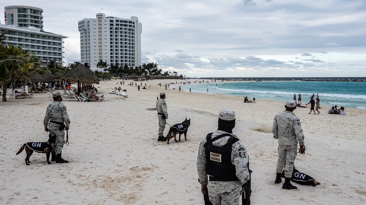 Members of the National Guard patrol a beach 