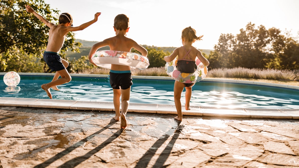 Children jumping in a pool