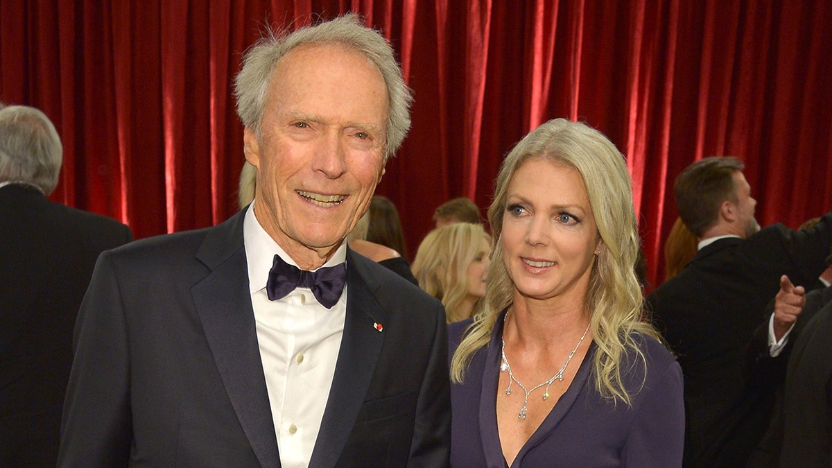 Clint Eastwood smiles next to girlfriend Christina Sandera.