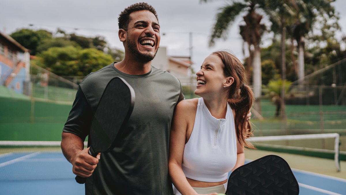 A couple playing pickleball