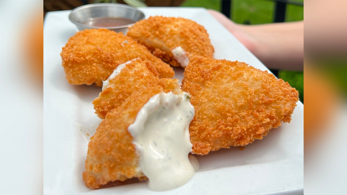 Deep fried ranch dressing, accompanied by a sauce. Panko-crusted ranch dressing.