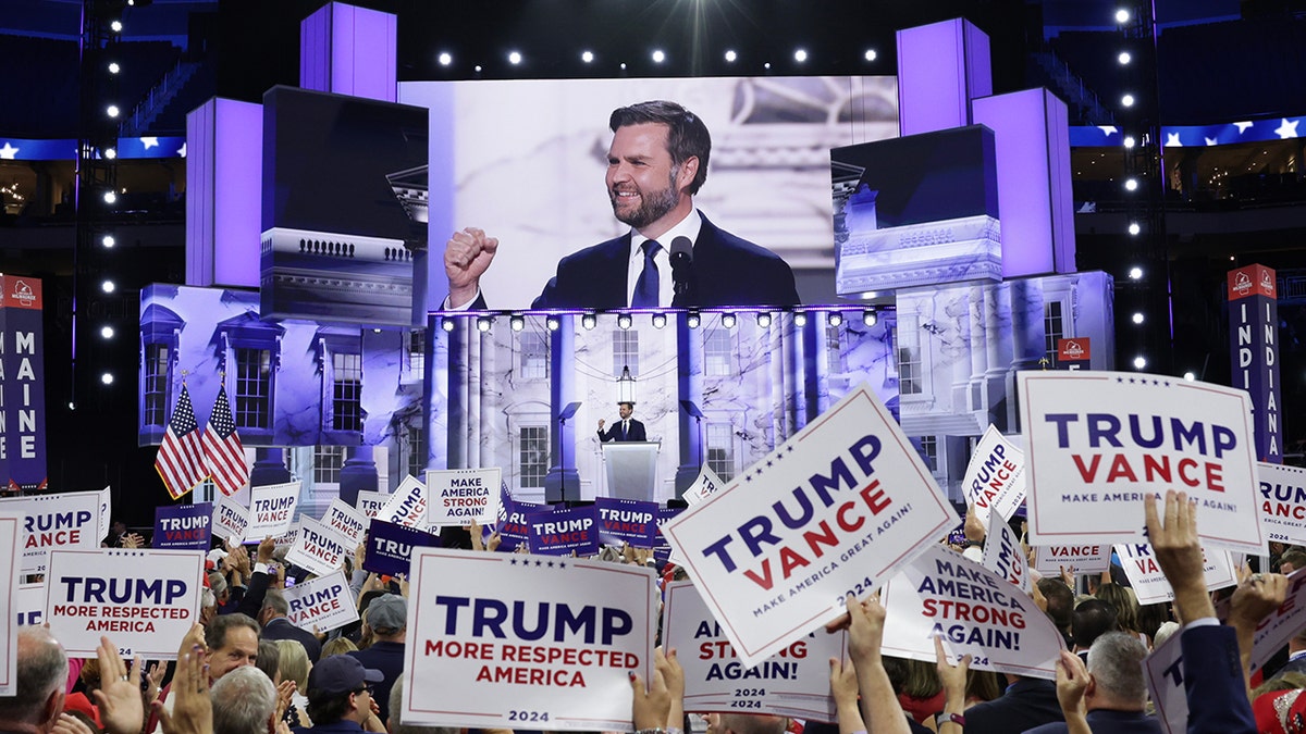 JD Vance on big screeen at convention with cheering GOP delegates below it