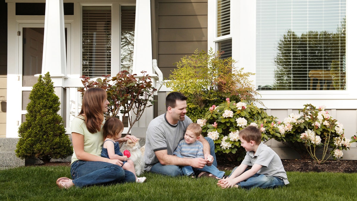 Family in the front yard of their house