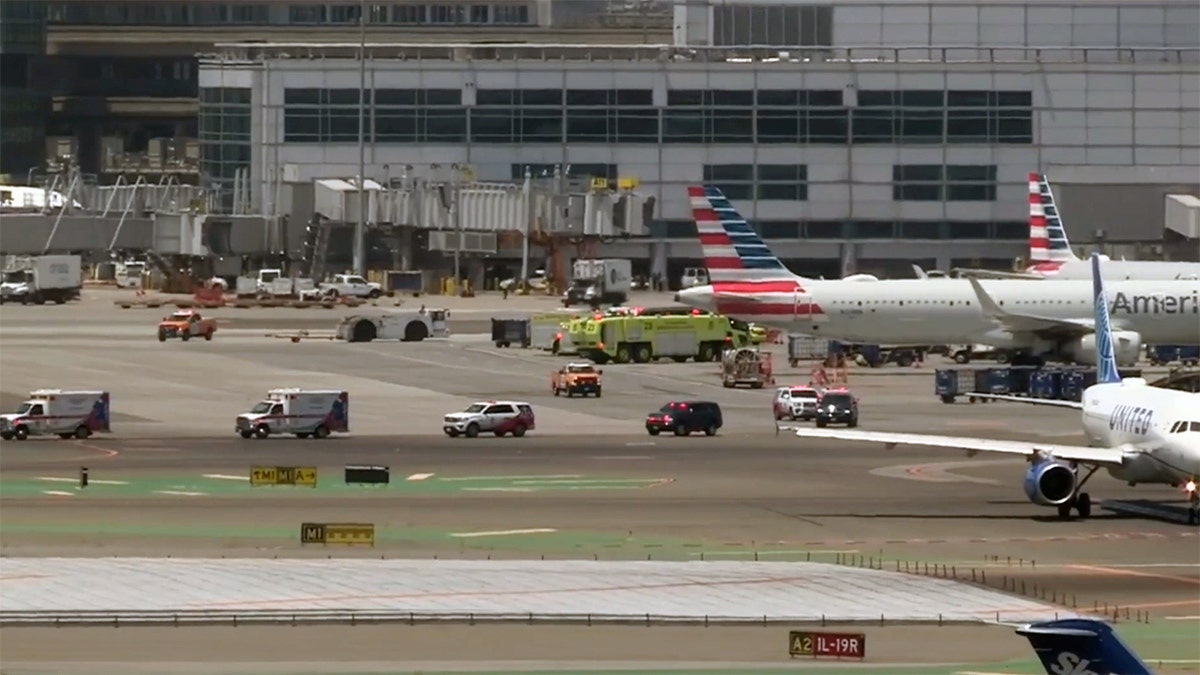First responders are present on the tarmac of an evacuated American Airlines flight