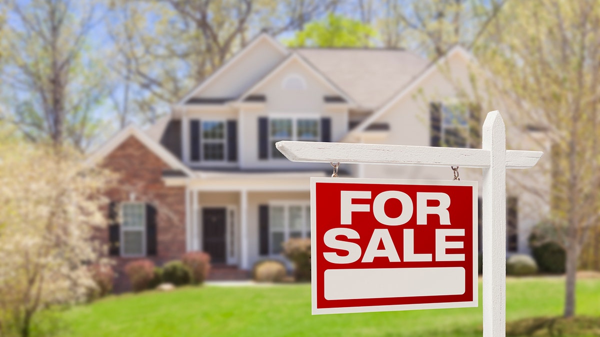 A for sale sign in front of a house