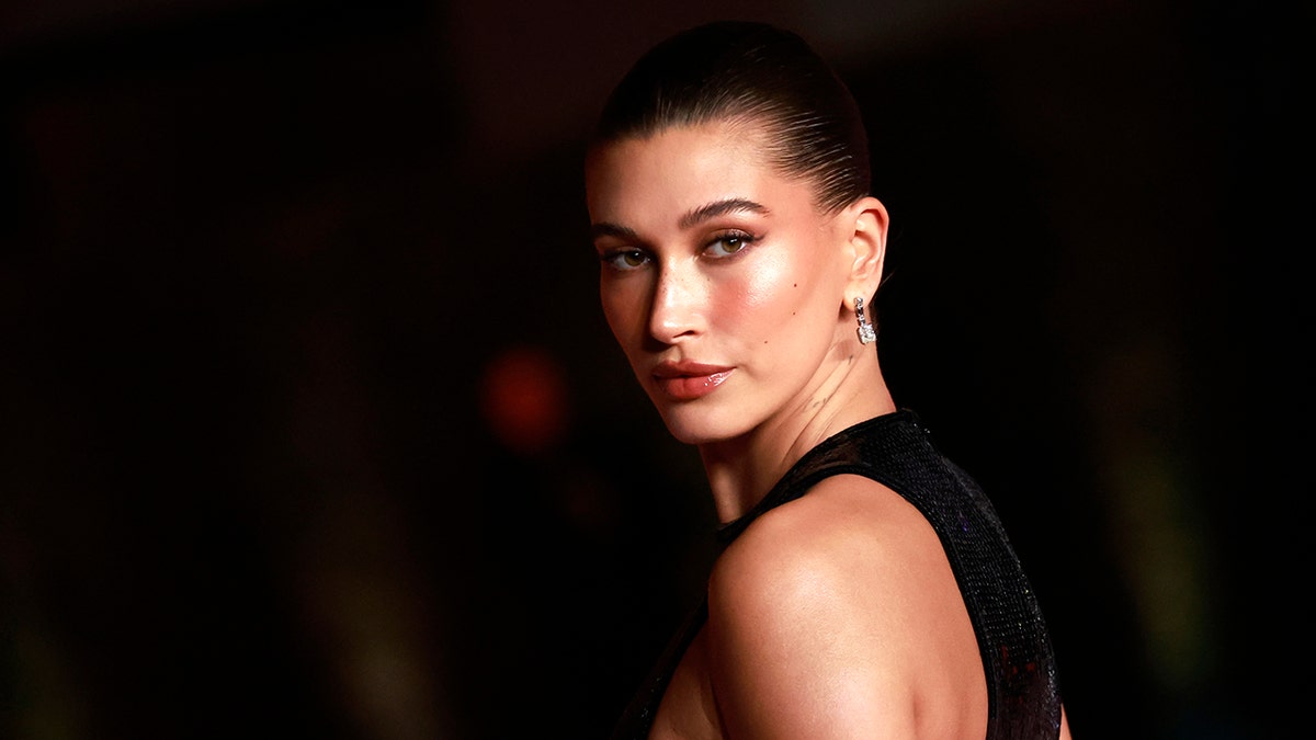 Hailey Bieber looks over the shoulder at the Annual Academy Museum Gala