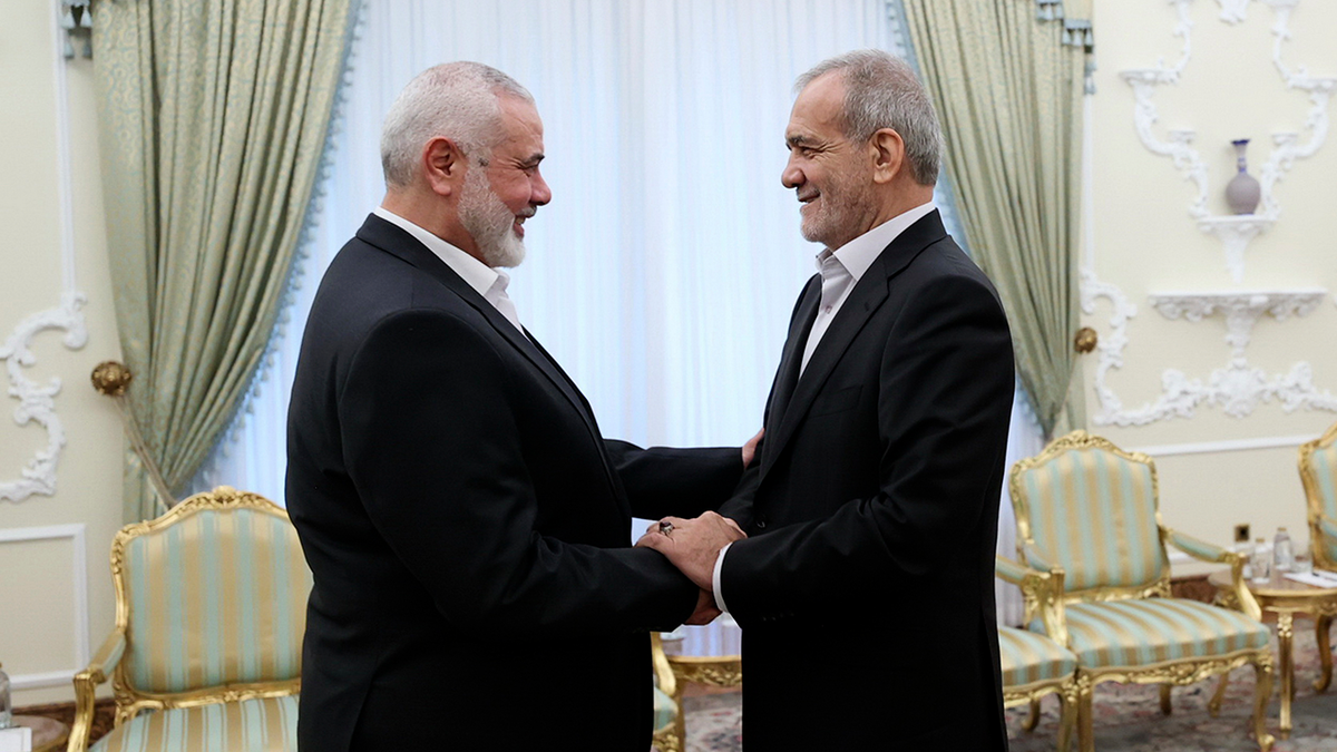 President Masoud Pezeshkian shakes hands with Hamas chief Ismail Haniyeh