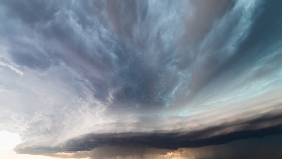 A derecho with dark storm clouds is seen ahead of a line of severe thunderstorms near Broadus, Montana.