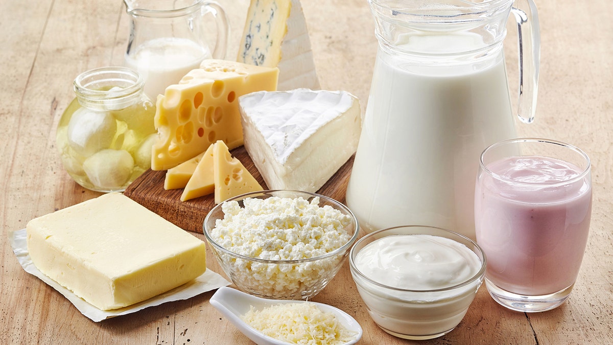 Various fresh dairy products on a wooden background.