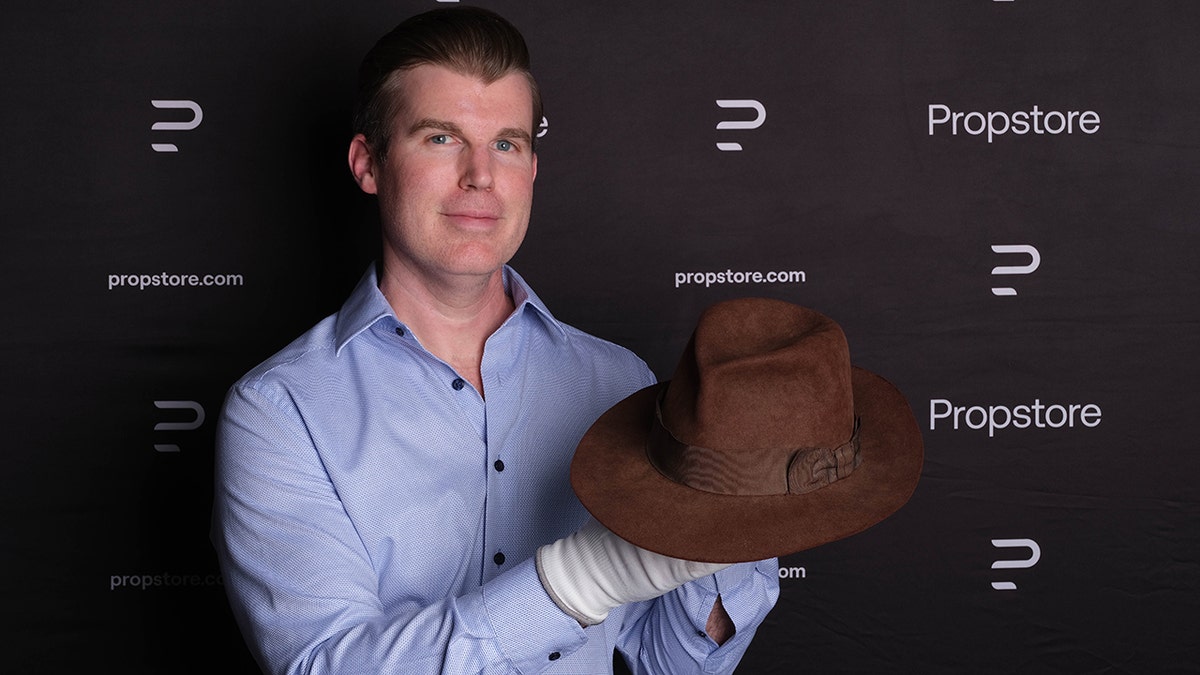 Brandon Allinger posing with Harrison Ford's hat from "Temple of Doom."