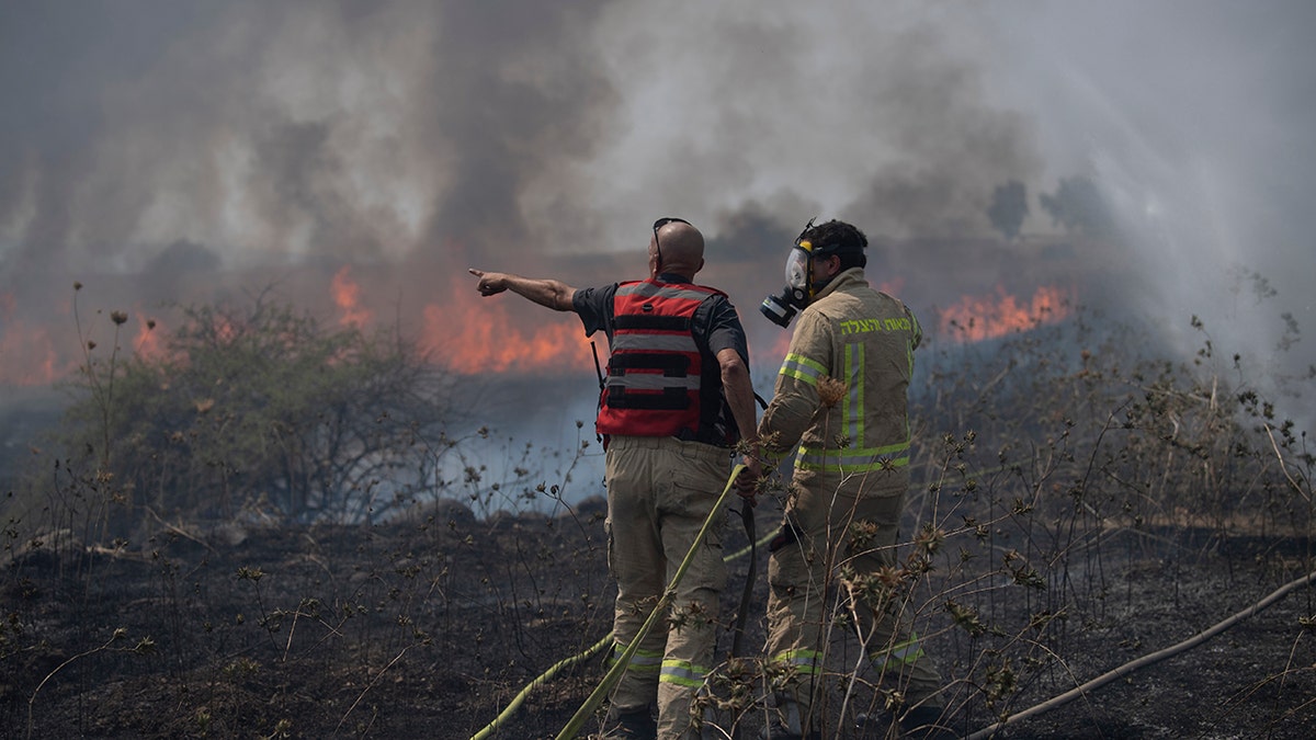 Firefighters work to extinguish a fire