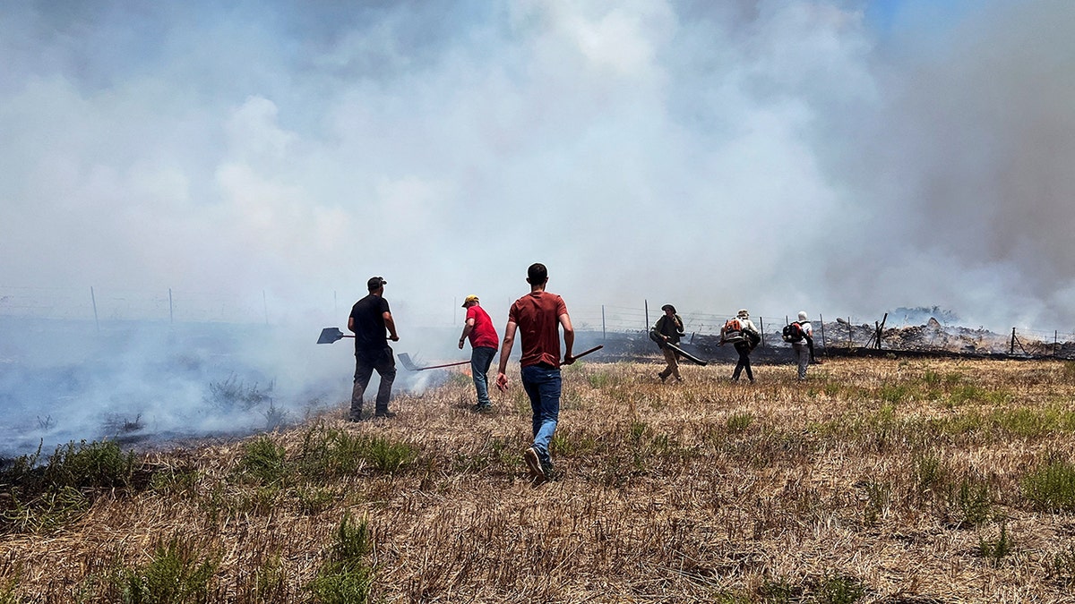 People work to put out fires