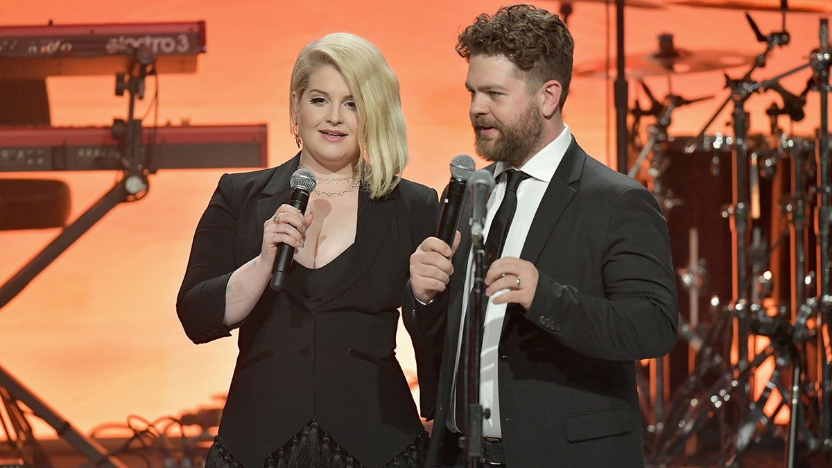 Kelly and Jack Osbourne speaking at an event
