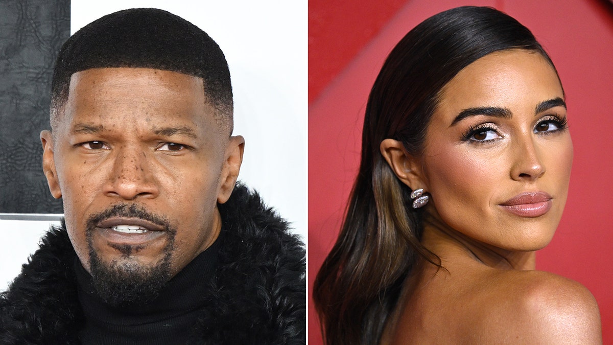 Jamie Foxx with a furry jacket on the carpet split Olivia Culpo in front of a red back drop looks over her shoulder
