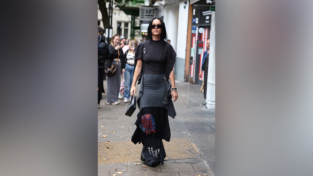 Perry walked the streets of New York in a layered black ensemble.