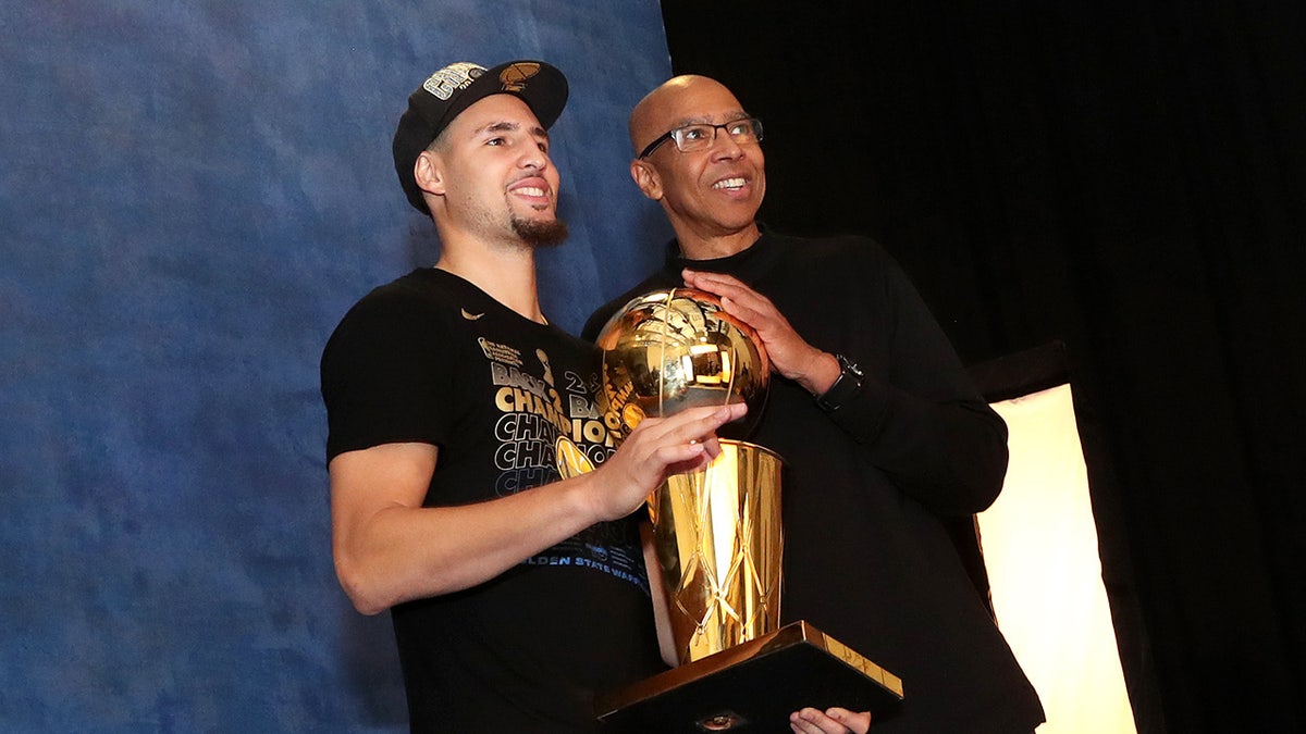 Klay and Mychal Thompson with the NBA trophy