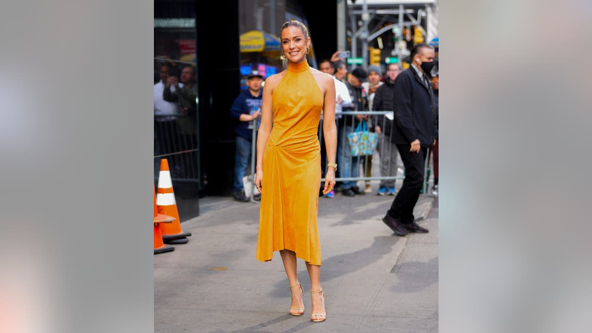 Cavallari in an orange dress