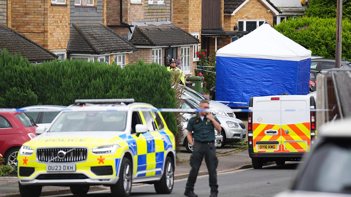 investigators outside homes in Bushey, England