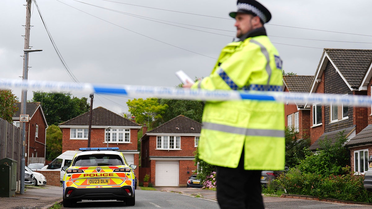 investigators outside homes in Bushey, England