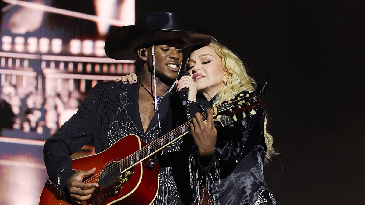 Madonna and her son David Banda perform at concert.
