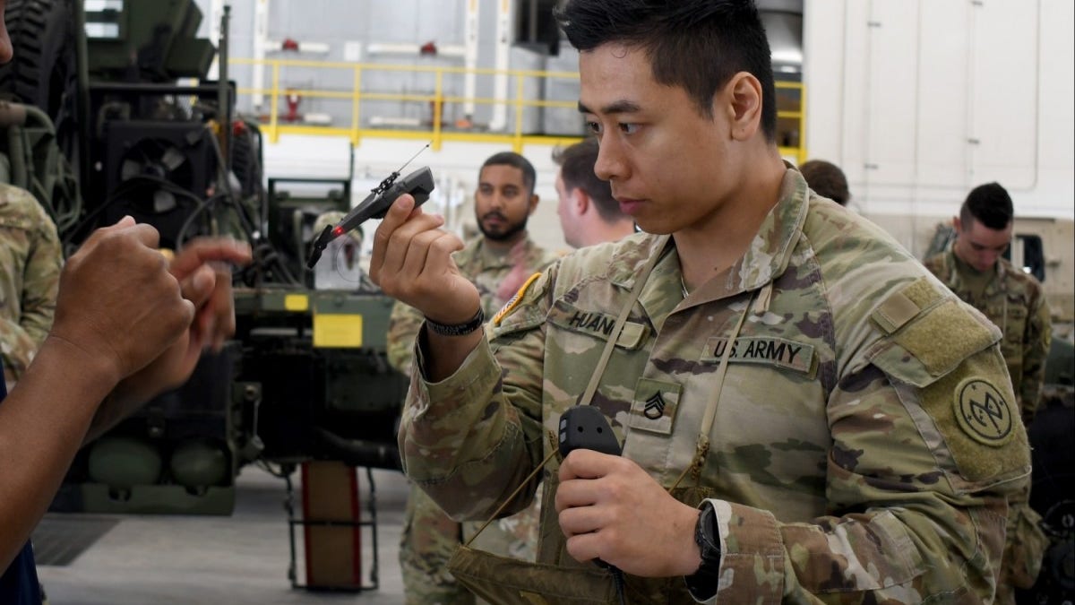 Army soldier holds small drone