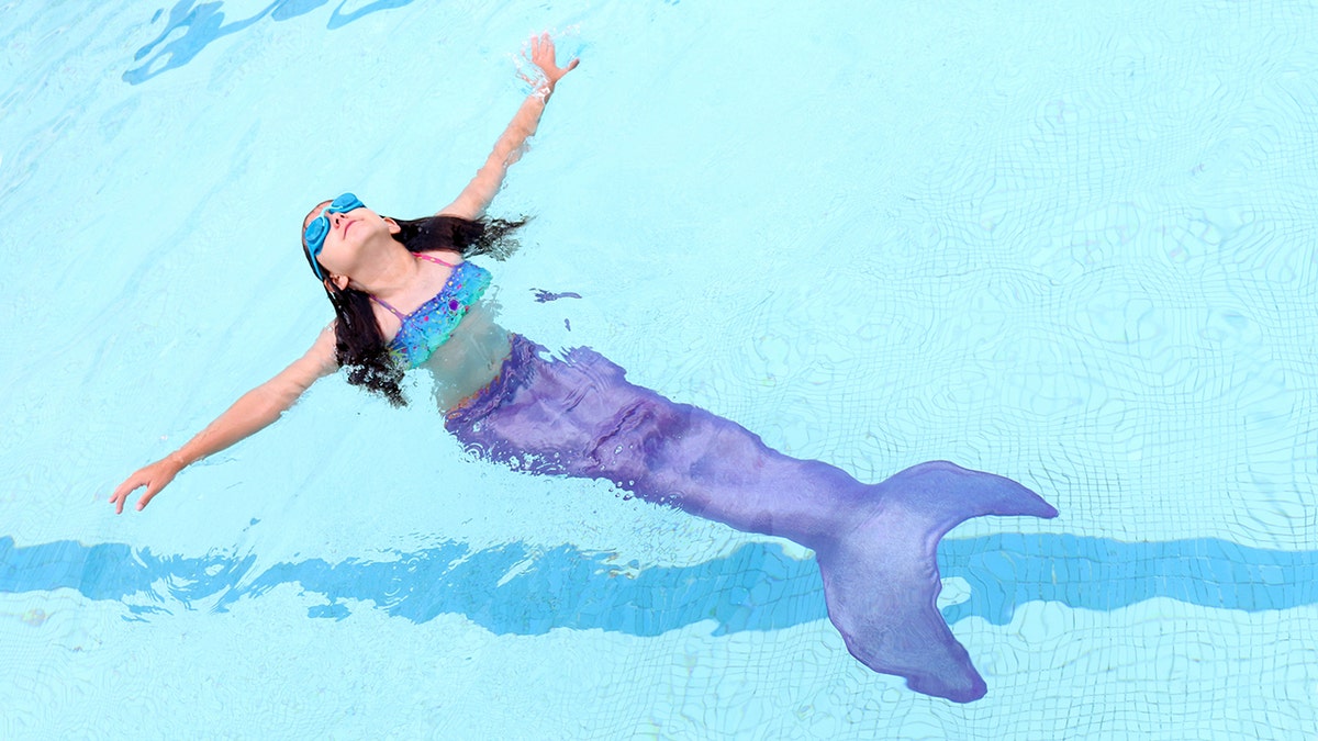 mermaid tail toy in pool
