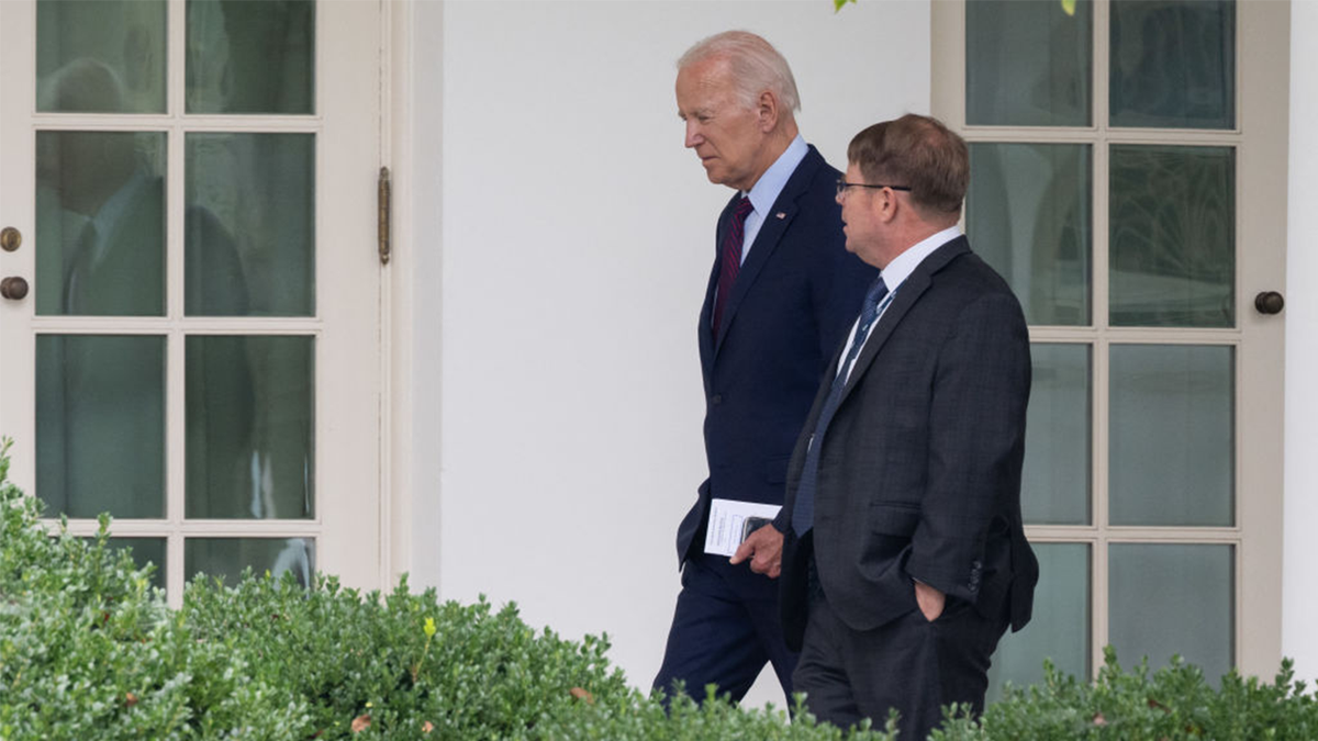 President Joe Biden walking with White House physician Kevin O'Connor