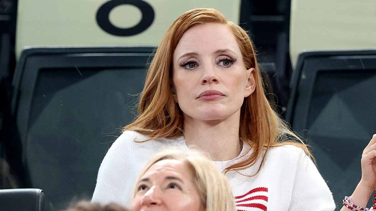 Jessica Chastain in a white America Olympic sweatshirt