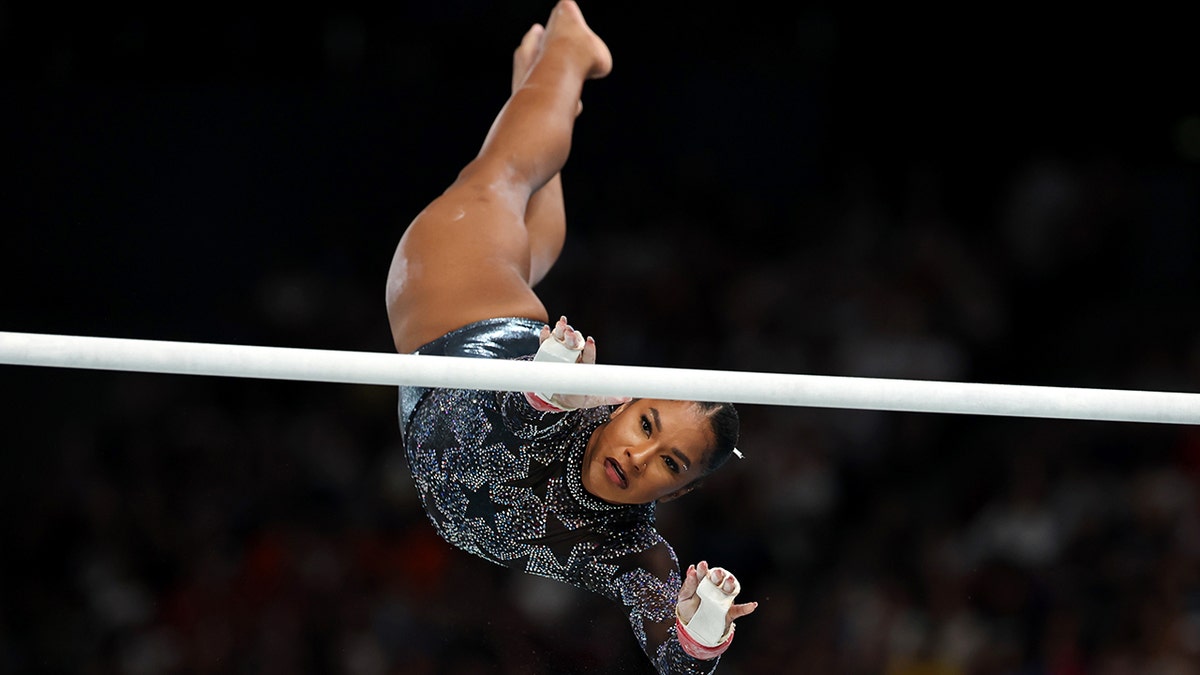 Jordan Chiles flies in the air on the parallel bars