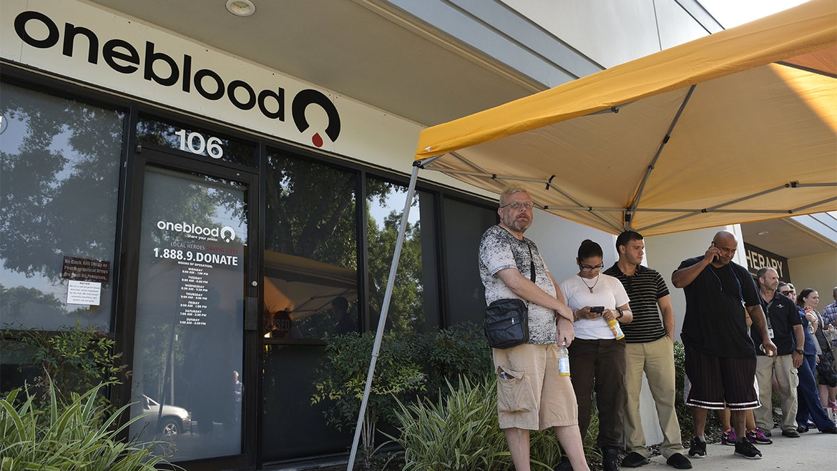 People wait in line to give blood at a OneBlood donation center in Orlando, Florida