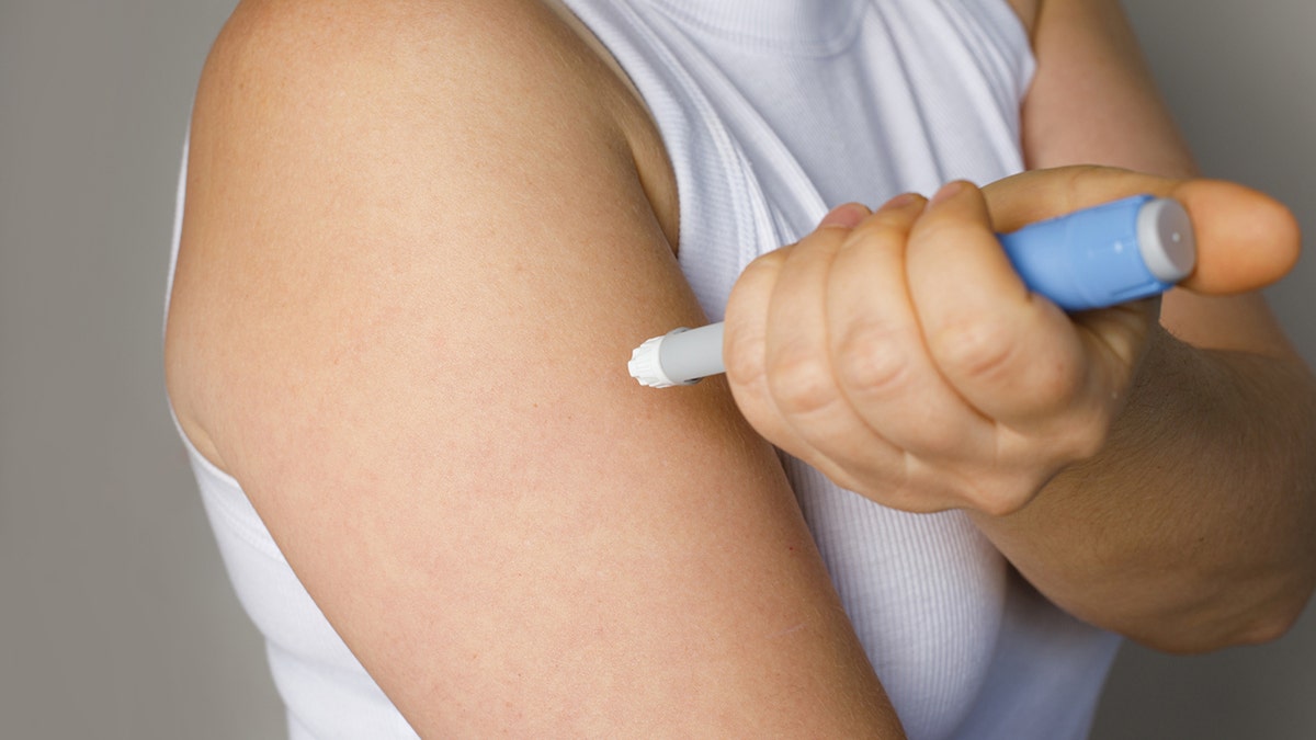 Person seen giving themselves an Ozempic injection to the arm
