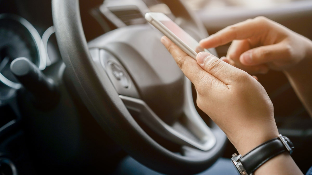 Person making a phone call in the car