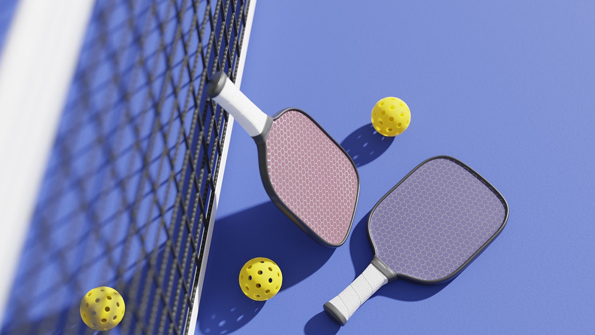 Pickleball paddles and balls on a court