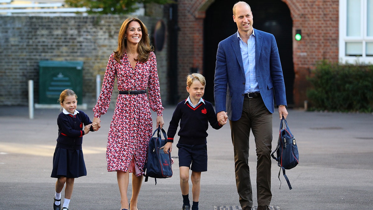 Princess Charlotte, Princess Catherine, Prince George and Prince William holding hands.