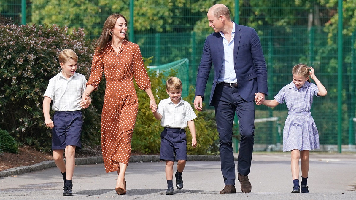 Prince George walked to his first day at a new school with his siblings and parents.