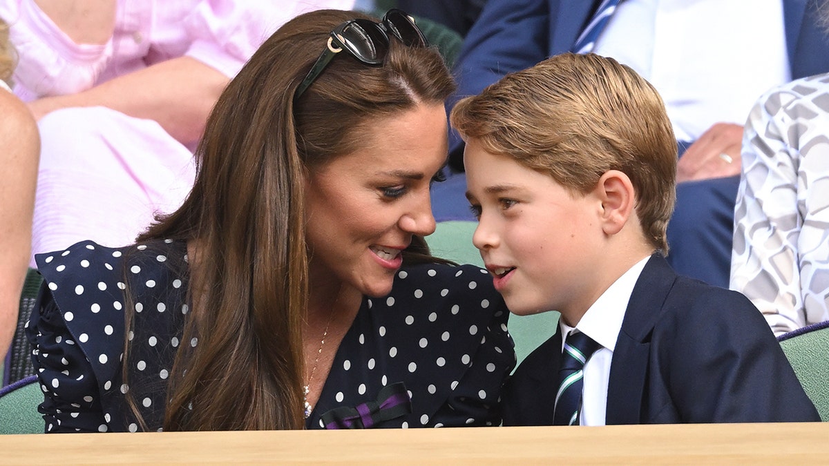 Prince George and Kate Middleton sharing whispers at the Wimbledon Men's Final in 2022.