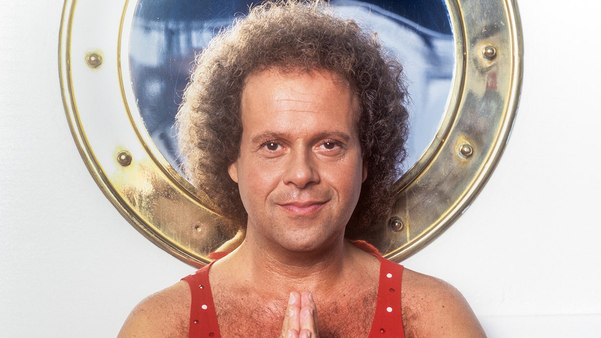 Richard Simmons wears red tank top with glitter