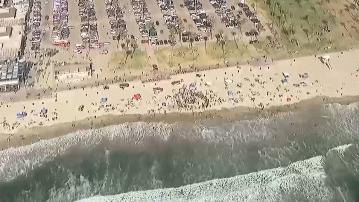 rescuers digging out teen at beach