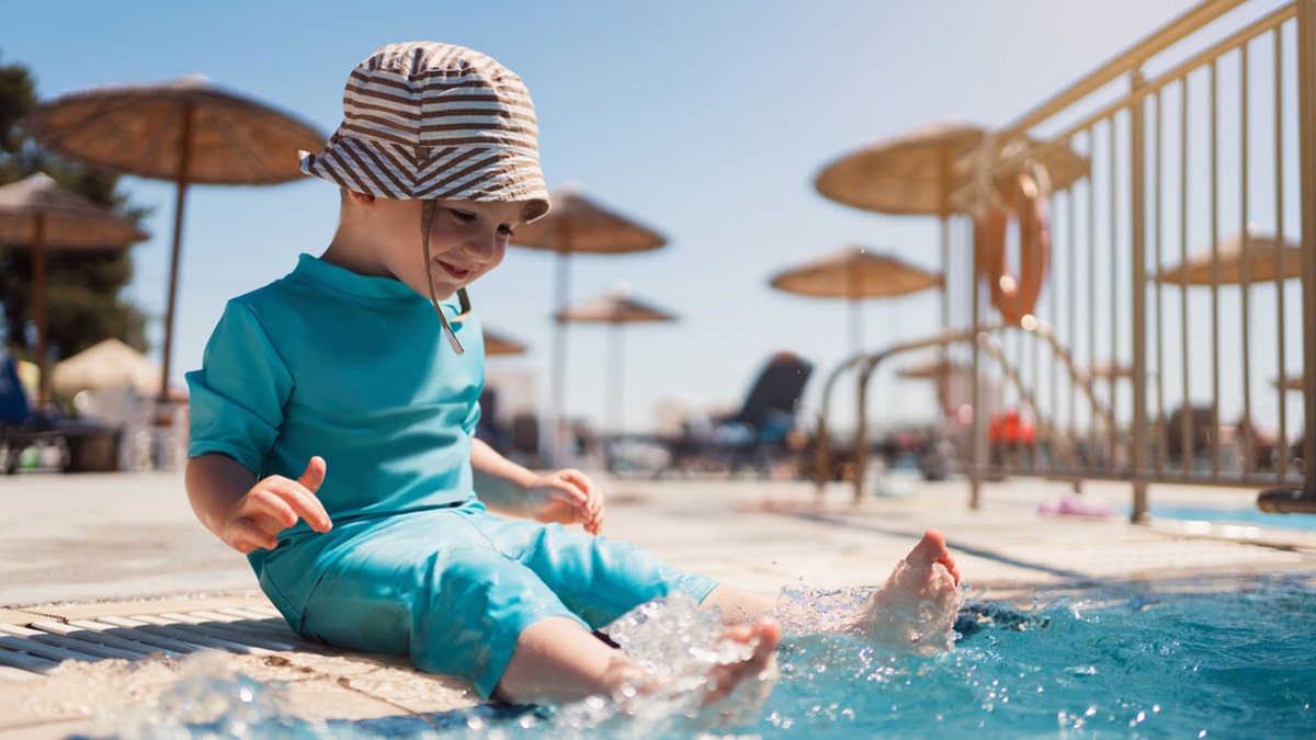 Toddler splashing in the pool