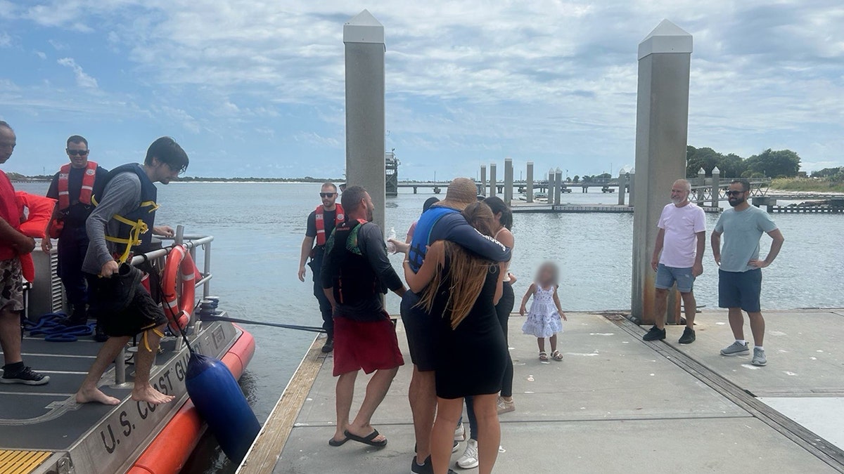 men reunited with family at boat ramp