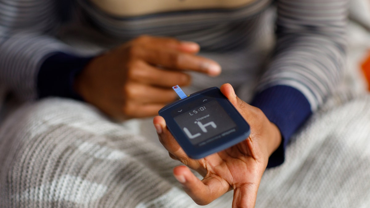 Woman checking her blood sugar level