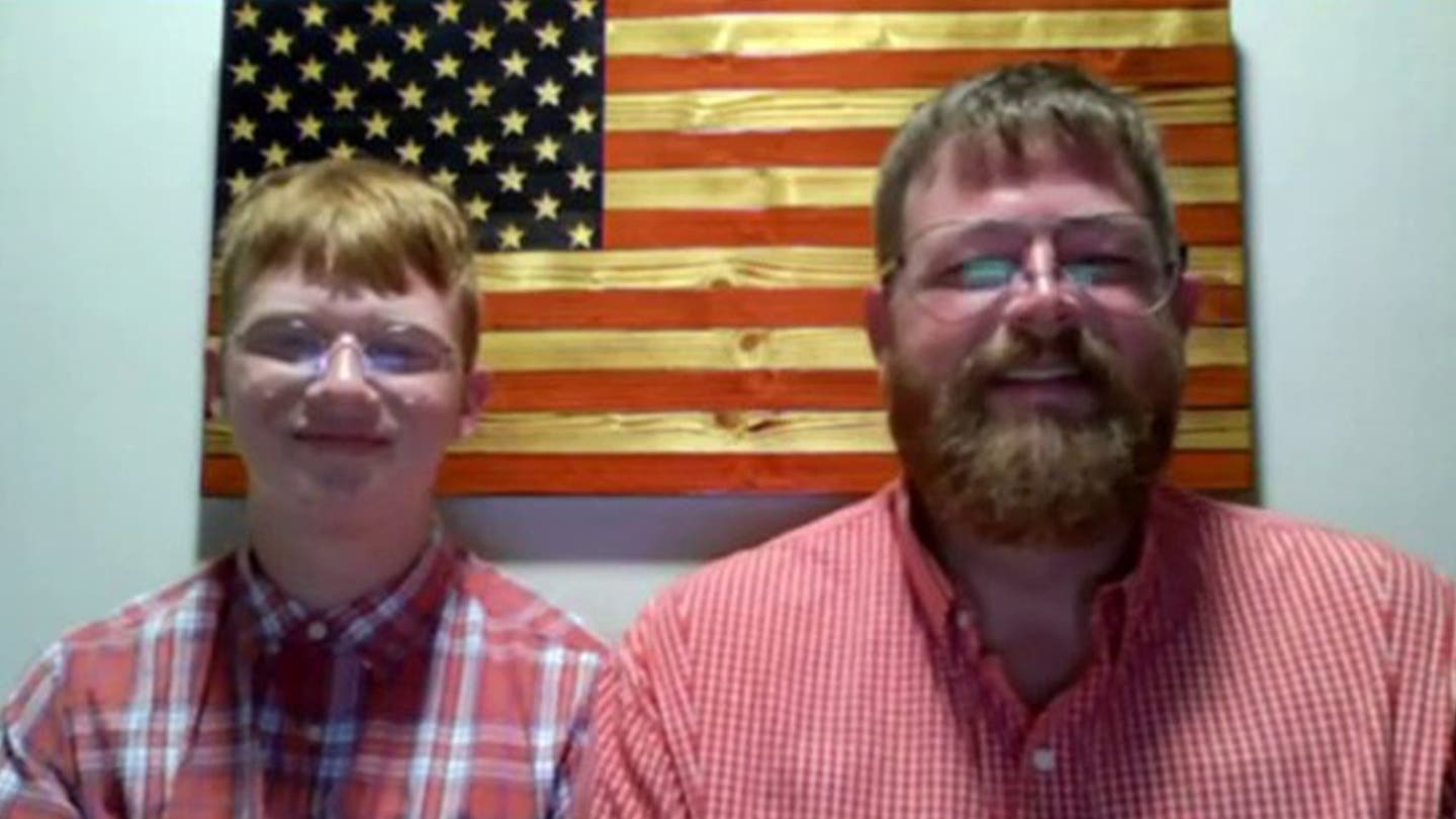 Family Draping House in 50-Foot American Flag on Independence Day