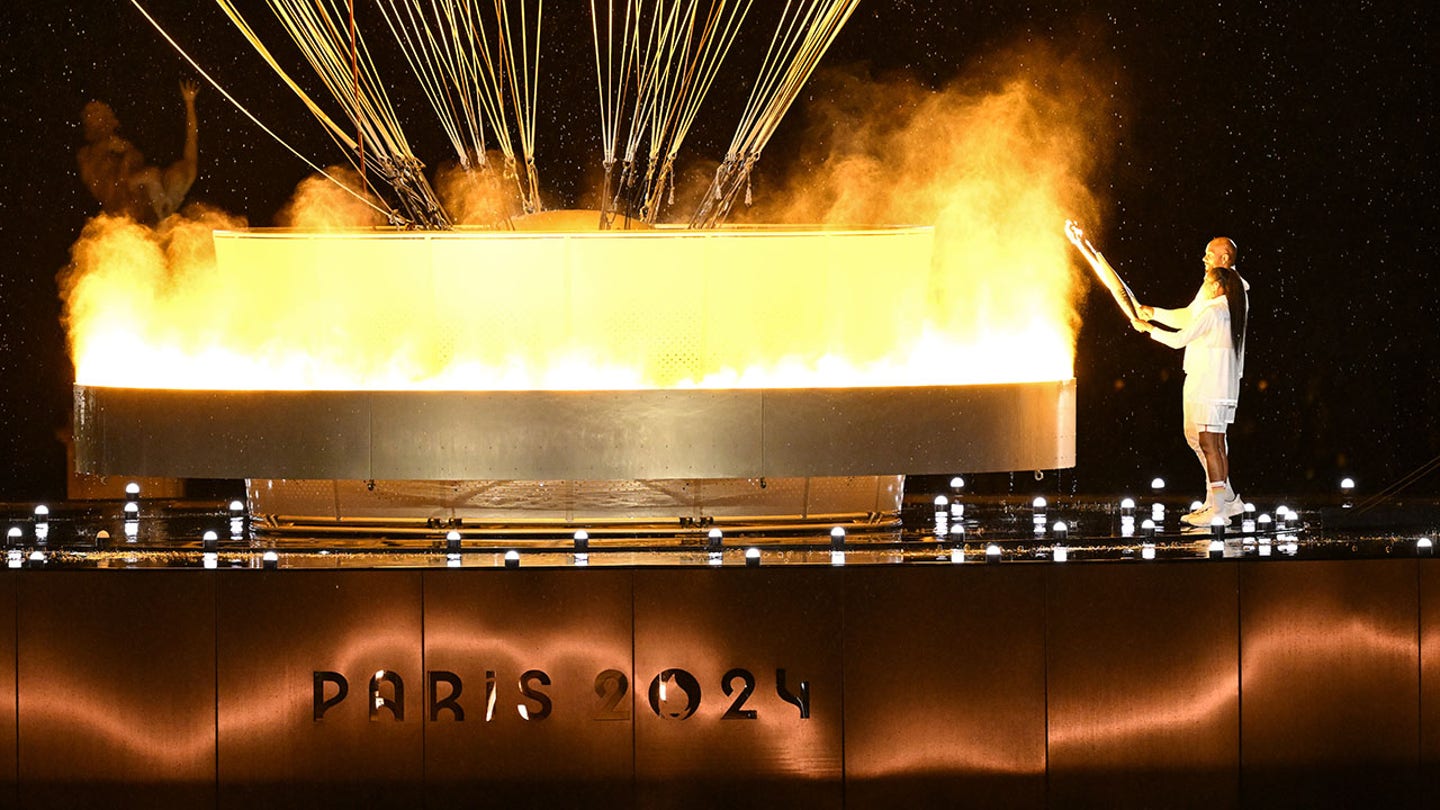 Lighting the Olympic Flame: French Legends Pérec and Riner Ignite Paris 2024