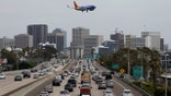 Nearly 71 million people are expected to travel between June 29 and July 7 around Fourth of July, according to AAA estimates. A Southwest Airlines Boeing 737-7H4 is pictured approaching San Diego International Airport for a landing from Houston as traffic on southbound Interstate 5 slows during the afternoon commute heading into downtown San Diego on June 28, 2024 in San Diego, California