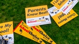 Signs lay in the grass during a rally celebrating National School Choice Week on Halifax Mall in front of the Legislative Building in Raleigh, North Carolina, on Jan. 24, 2024. North Carolina could see a 60 percent increase this year in the number of students receiving a private school voucher now that income limits for families have been removed. (Travis Long/Raleigh News &amp; Observer/Tribune News Service via Getty Images)