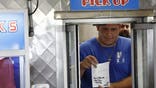 PHILADELPHIA, PENNSYLVANIA - JUNE 22: A restaurant worker holds up a receipt with a note that reads "Vote Trump No Tax on Tip" from Republican presidential candidate, former U.S. President Donald Trump at sandwich stop Tony and Nicks steaks on June 22, 2024 in Philadelphia, Pennsylvania. Trump will deliver remarks later today at a campaign rally at the Liacouras Center. (Photo by Anna Moneymaker/Getty Images)